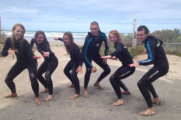 surfers posing with their wetsuit hired in Surf and Sun
