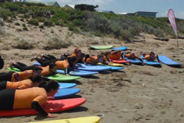 students, surfboard and sand for surf lessons south australia